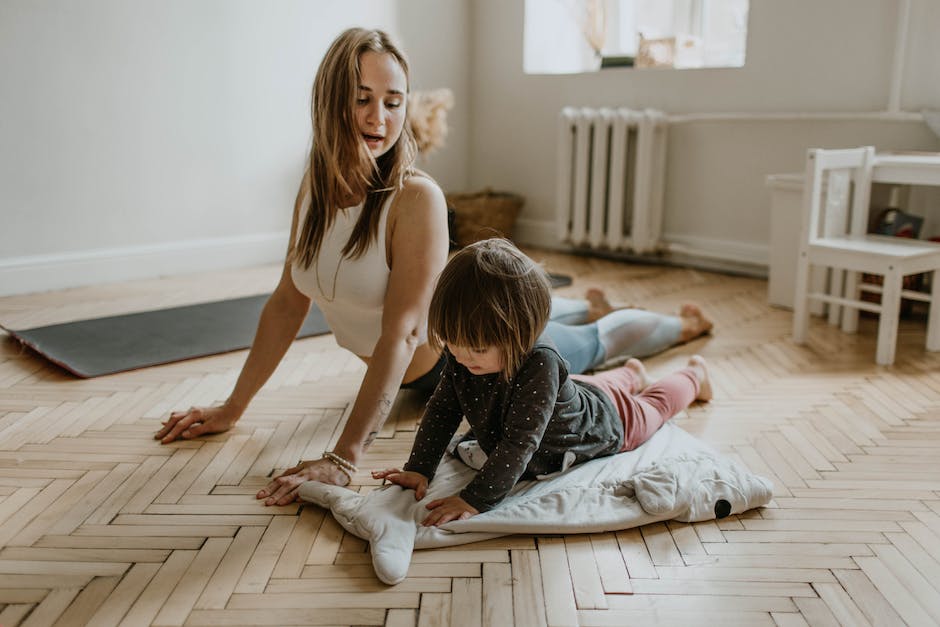 woman and a child doing yoga indoors