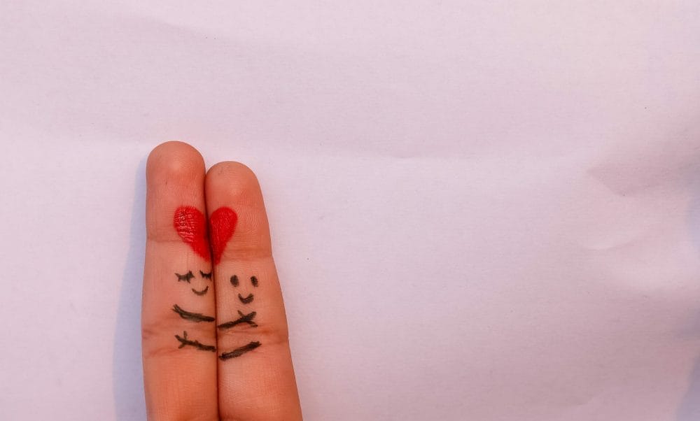 heart-scopio-473f22a4-b546-4875-a26d-475dcd1b205b 2 hand fingers of 2 people with half a hear on each completing a full red heart