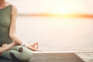 woman_doing_yoga_at_sunset