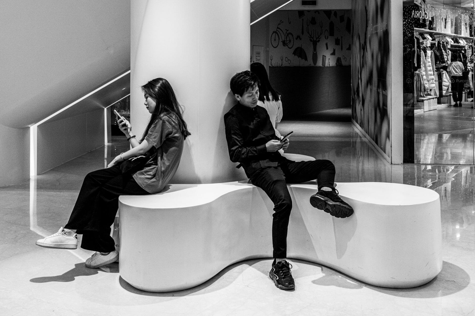 couple-sitting-on-their-phone