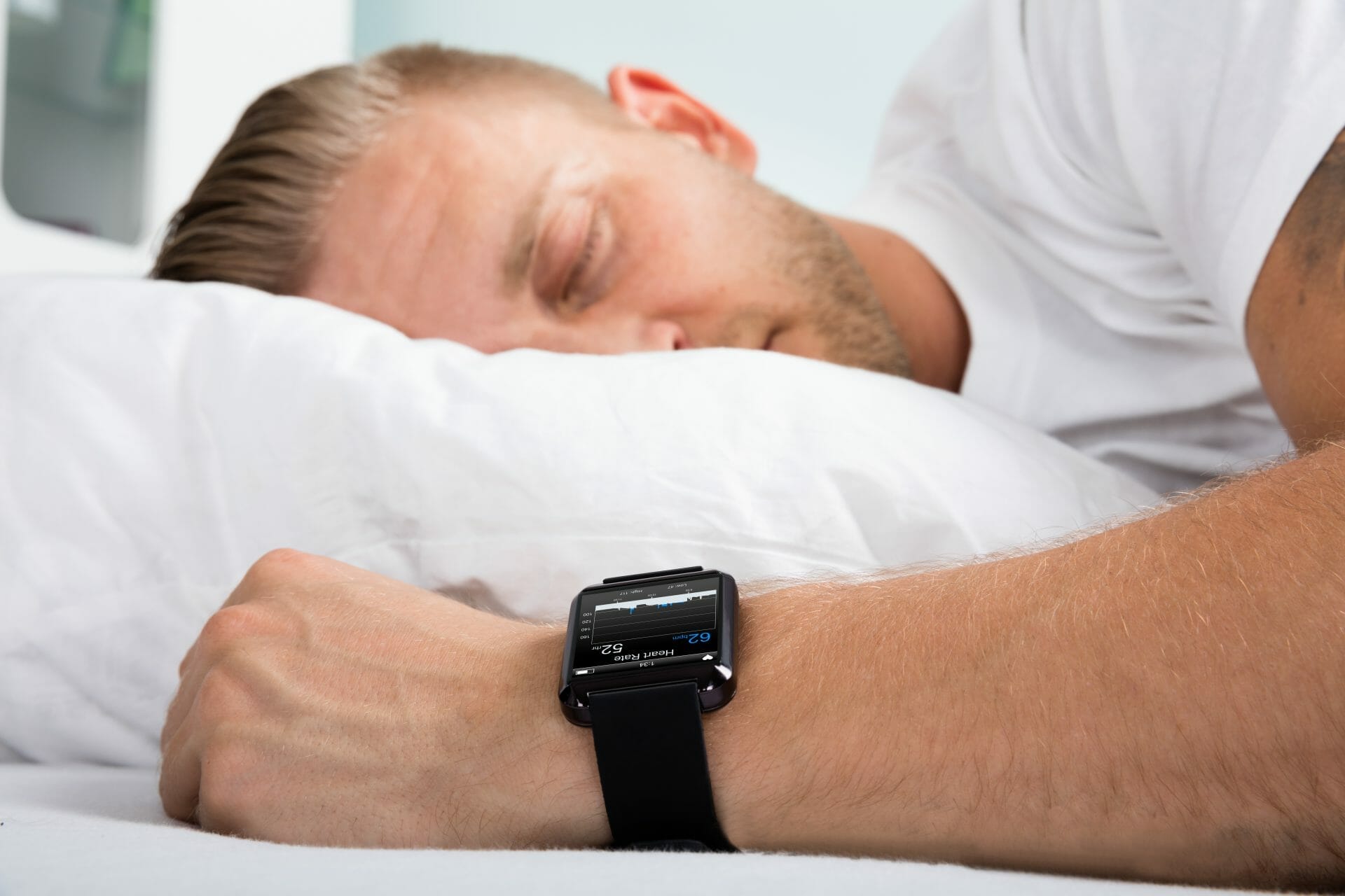 man is sleeping with a smart watch sleep tracking