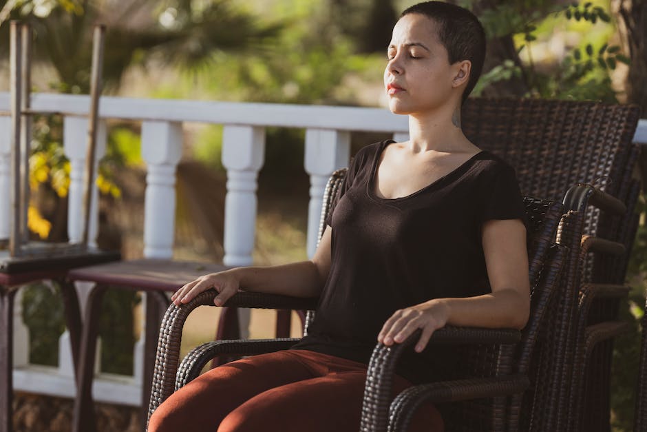 woman-sitting-and-meditating-on-a-chair-outside